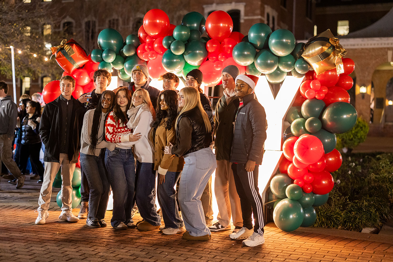 A group of people surrounded by lights and balloons