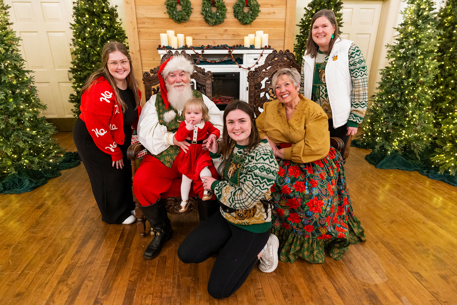 A family with Santa and Mrs. Clause