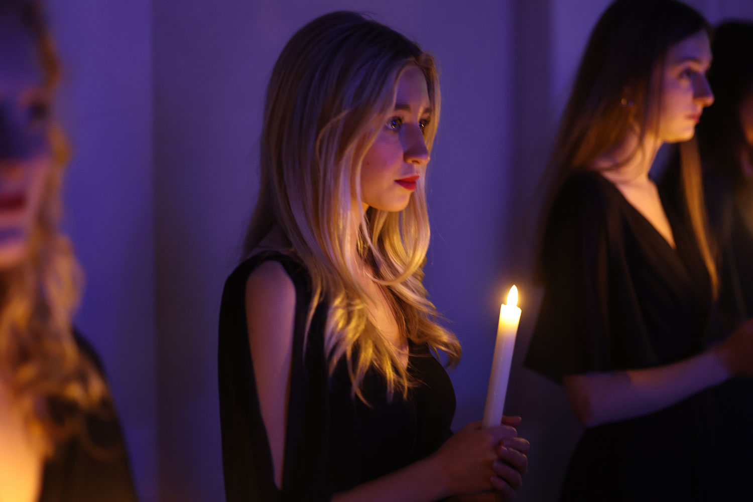 Baylor student holding a candle